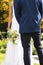Midsection of african american bride with bouquet and groom standing in sunny garden