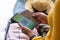 Midsection of african american woman holding passport and covid-19 vaccine certificate on smartphone