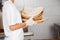 Midsection Of Baker Holding Bread Waste In Bakery