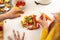 Midsection of biracial lesbian couple peeling vegetables in kitchen at home