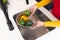 Midsection of biracial woman washing vegetables in kitchen sink at home