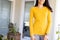 Midsection of biracial woman wearing yellow long-sleeve shirt with copy space