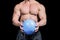 Midsection of bodybuilder exercising with ball