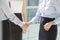 Midsection of businesswomen shaking hands in office