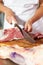 Midsection Of Butcher Slicing Fresh Raw Meat