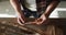 Midsection of caucasian male knife maker in workshop, holding knife