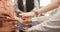 Midsection of diverse businesswomen stacking hands at office, in slow motion