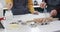 Midsection of diverse couple baking christmas cookies in kitchen at home, in slow motion