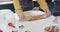 Midsection of diverse couple baking christmas cookies in kitchen at home, in slow motion