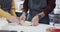 Midsection of diverse couple baking christmas cookies in kitchen at home, in slow motion