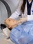 Midsection Of Doctor Adjusting Patient\'s Face Before MRI Scan