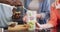 Midsection of group of diverse friends preparing healthy drink in kitchen together