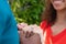 Midsection of happy biracial couple holding hands with engagement ring in garden