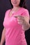 Midsection of happy caucasian woman in pink tshirt holding pink ribbon