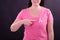 Midsection of happy caucasian woman in pink tshirt with pink ribbon gesturing