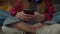 Midsection of Latin teenager girl playing online game on cellphone