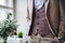 A midsection of man with formal suit standing on an indoor party.