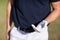 Midsection of man holding golf ball