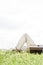 Midsection of man lying by vintage radio on grass against clear sky