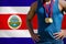 Midsection of medalist against Costa Rican Flag