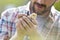 Midsection of mid adult man holding small chick at farm