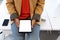 Midsection of mixed race businesswoman sitting on desk using tablet in creative office