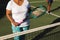 Midsection of senior african american woman holding tennis racket on tennis court