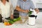 Midsection senior caucasian couple in modern kitchen, cooking together composting organic waste