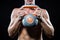 Midsection of shirtless athlete holding kettlebell