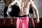 Midsection Of Shirtless Trainer Holding Medicine Ball