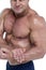 Midsection of smiling bodybuilder flexing muscles