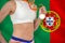 Midsection of sportswoman with medal against Portuguese Flag