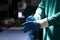 Midsection of surgeon putting on gloves in dark operating theatre, with copy space