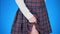 Midsection of teenage girl, cheat sheet written on hips hidden under a skirt. 4k, close-up, blue background, slow-motion