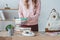 midsection view of female student with books and backpack on table