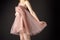 midsection view of tender girl posing in pink chiffon dress,
