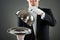 Midsection Of Waiter Holding Cloche Over Empty Tray