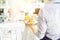 Midsection of waiter serving lunch to mature customer sitting at table in restaurant