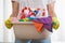 Midsection of woman carrying basket of cleaning supplies