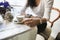 Midsection of woman having coffee at cafe