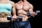 Midsection of woman and man exercising with dumbbells