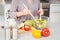 Midsection of woman preparing salad