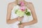 Midsection of young bride holding fresh bouquet