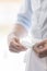 Midsection of young waiter cleaning fork in restaurant