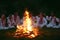 Midsummer night. Young people in Slavic clothes sitting near the bonfire