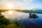 Midsummer sunrise over river curve in the countryside