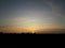 Midsummer sunset with stripe clouds, blue and orange sky