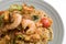 Mie goreng, fried yellow noodle prawn seafood vegetable tomato egg garlic shallot onion shrimp famous indonesian spicy dish.