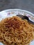 Mie goreng. Instant noodles. Fried noodles. Fried noodles are placed on a plate. Fried noodles from Indonesia. Closeup photo.