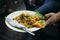 Mie Goreng served with chili sauce and cutlery from street night market in Jakarta, Indonesia